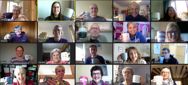 People holding up coffee cups on Zoom call