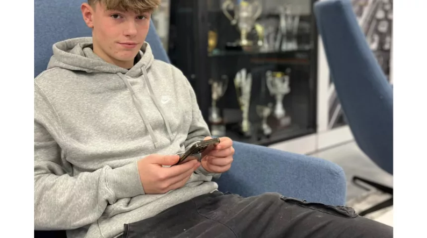 Boy sat looking at his phone