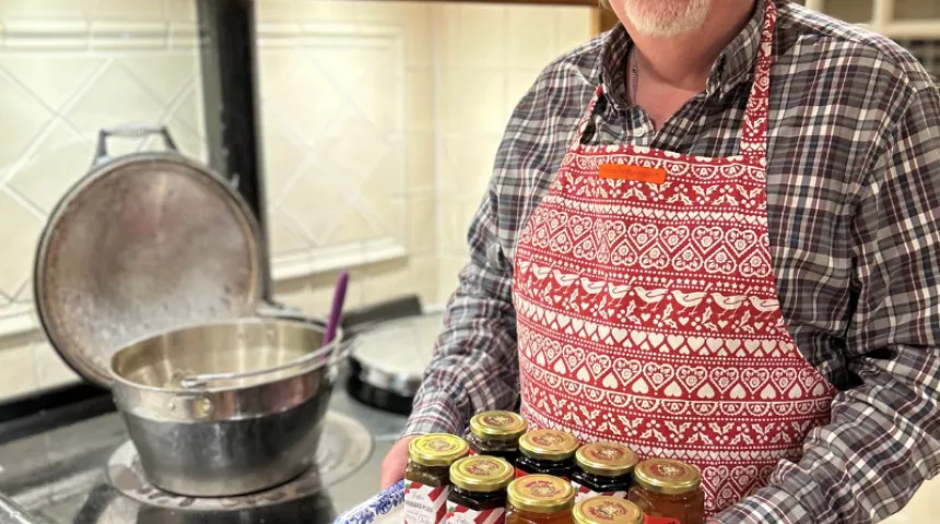 Alister holding homemade jams and preserves