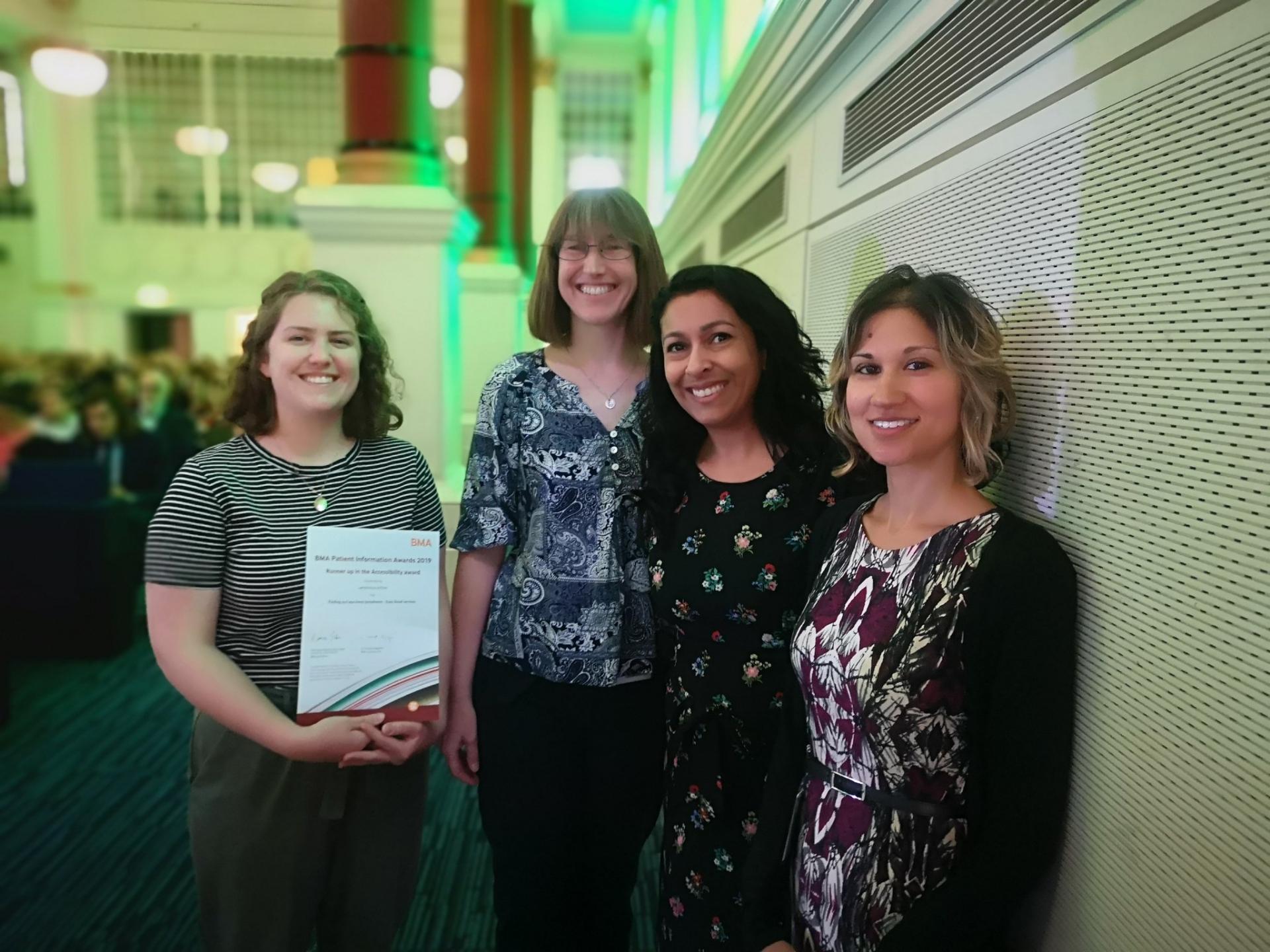 Publications Team with one of their awards