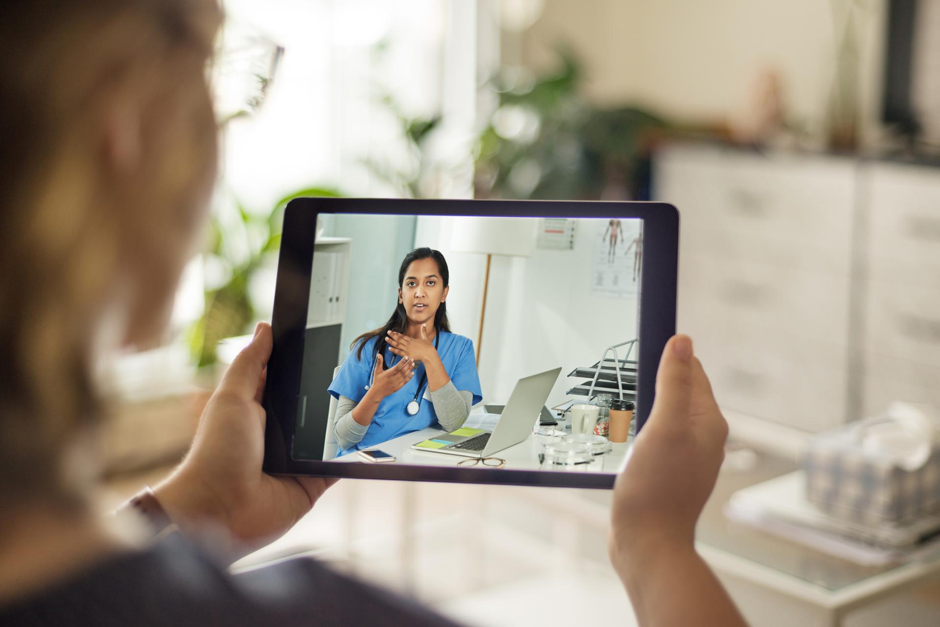 Woman having an appointment with her doctor by iPad