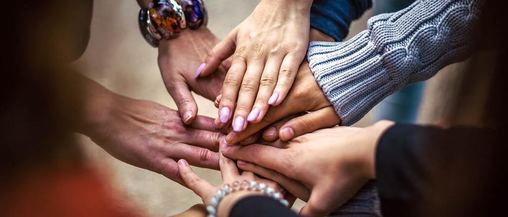 Group of people with their hands stacked on top of each other