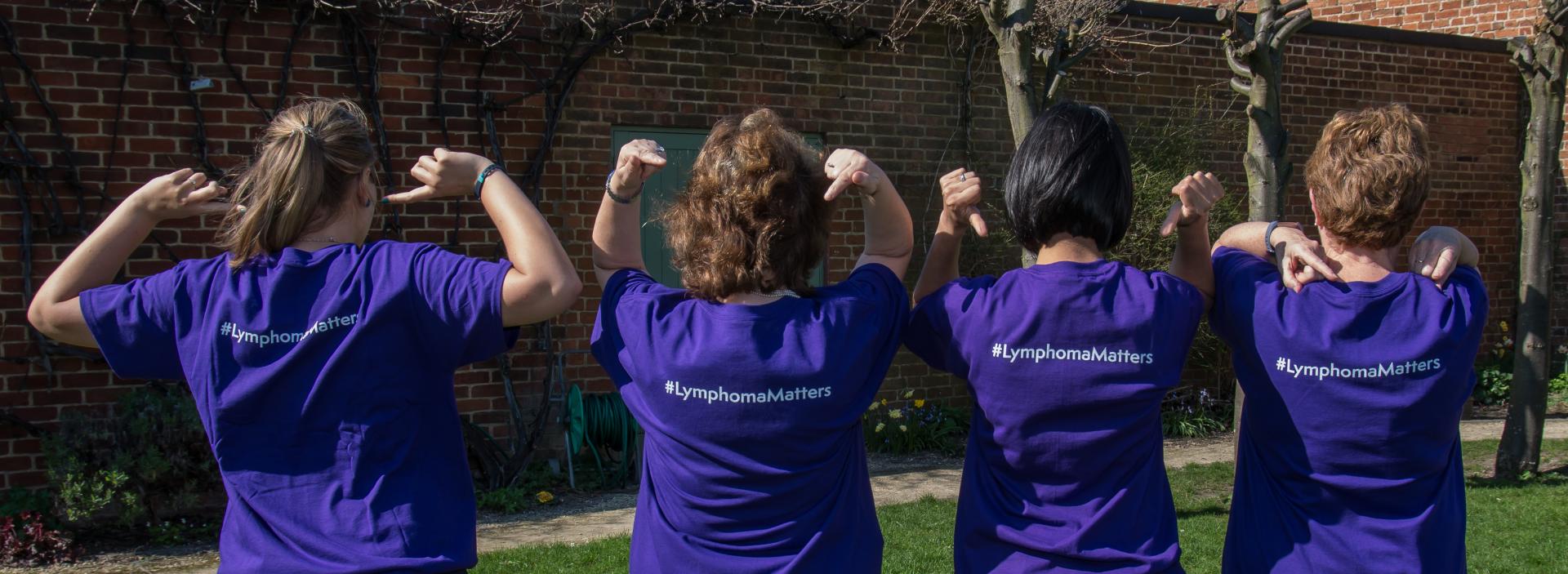 Four people in purple shirts with Lymphoma Matters written on the back