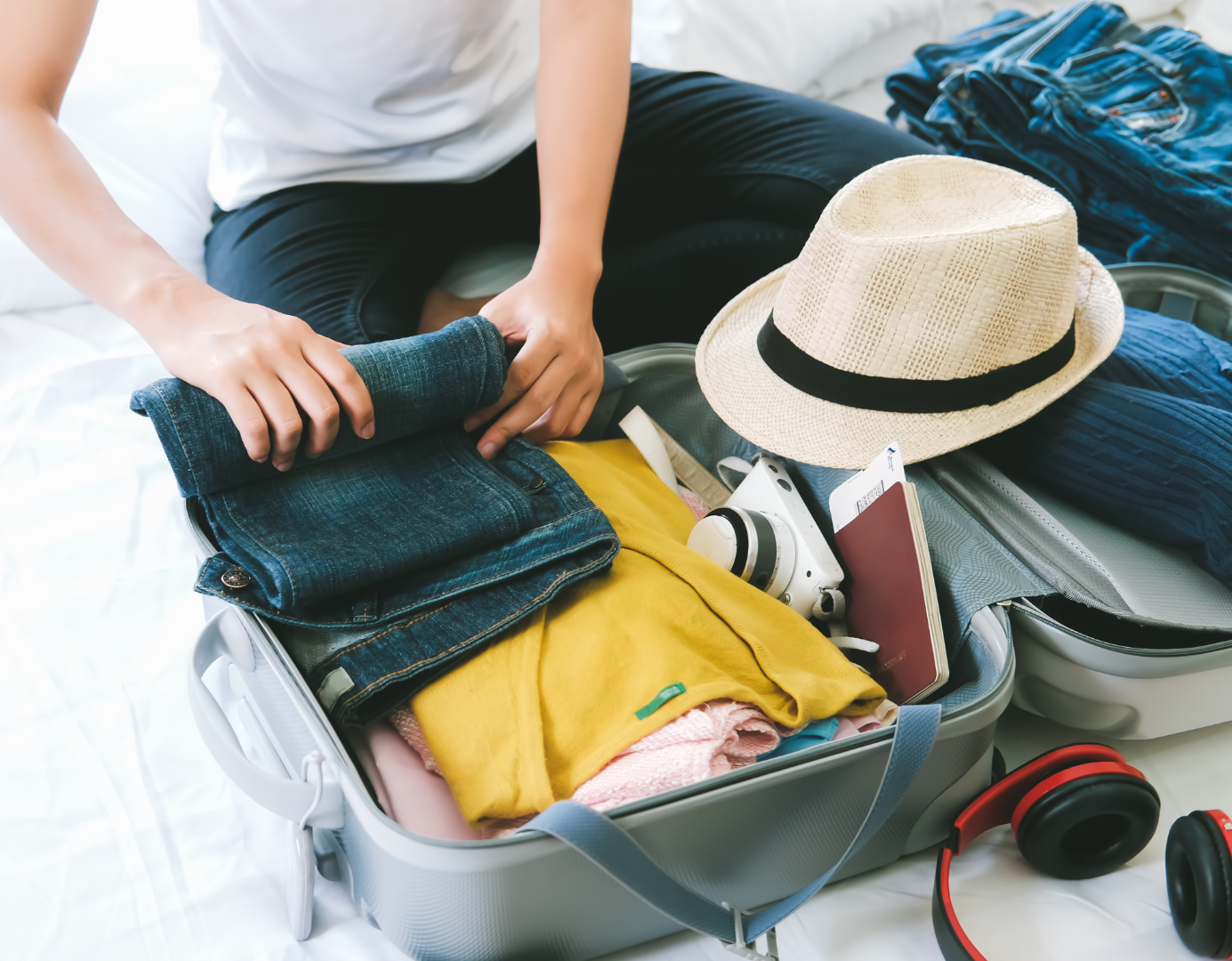 Person packing suitcase for a summer holiday