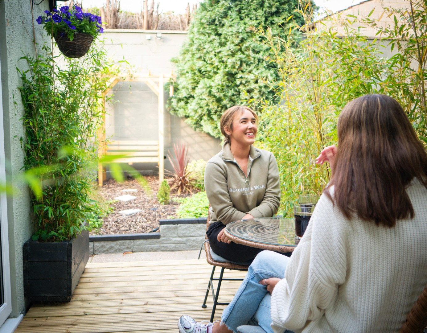 Georgia speaking to friend in a garden 