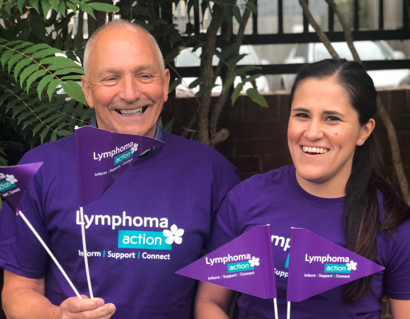 Two Lymphoma Action volunteers waving flags