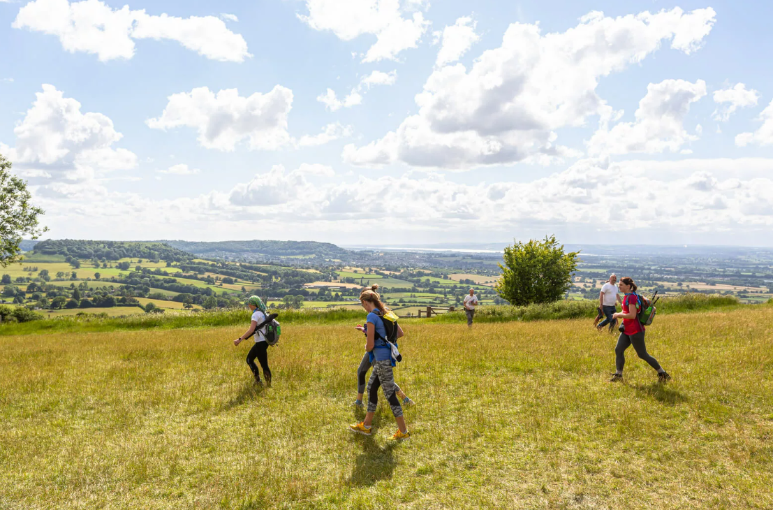 4 walkers walking through the countryside 