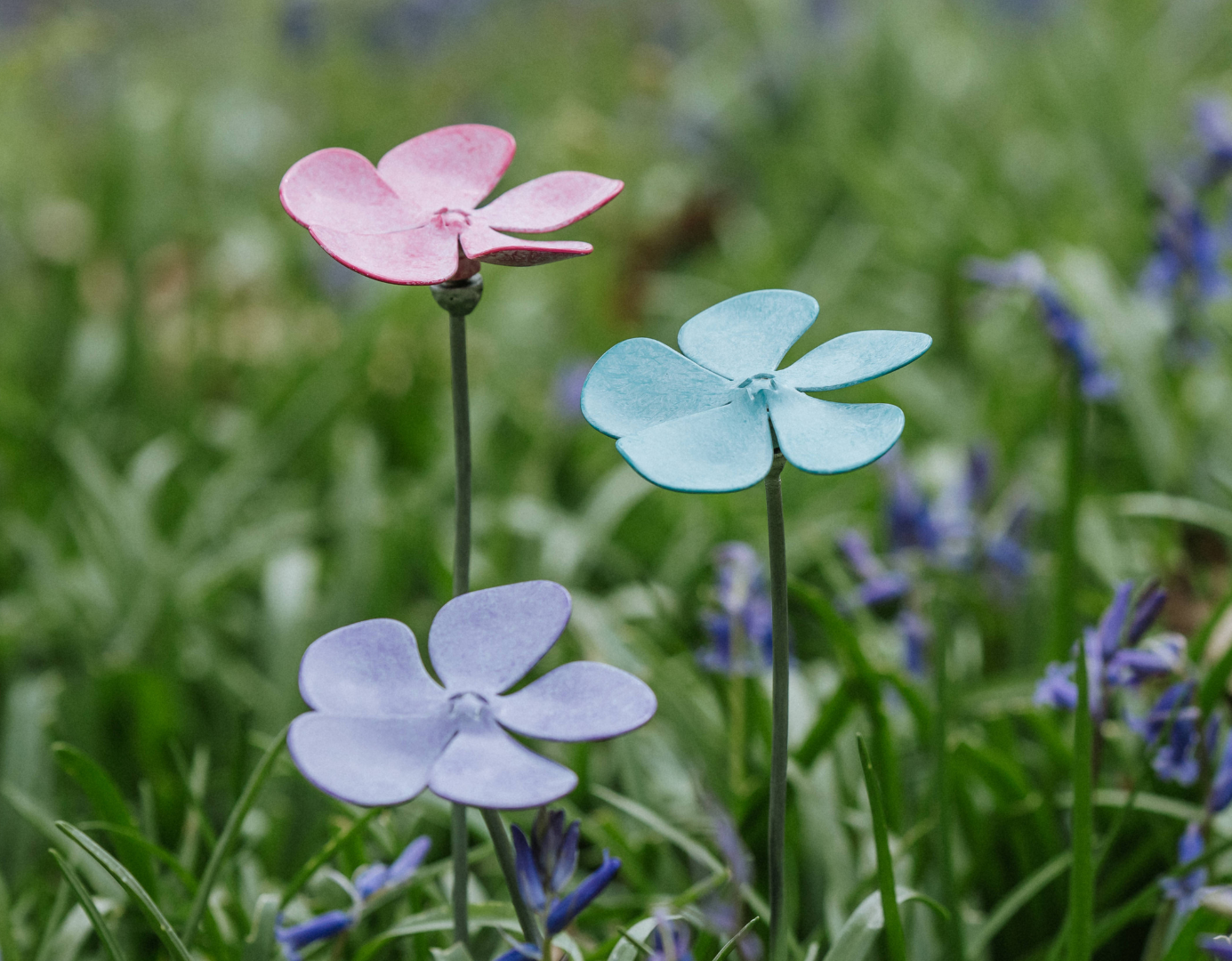 Three metal periwinkle sculptures