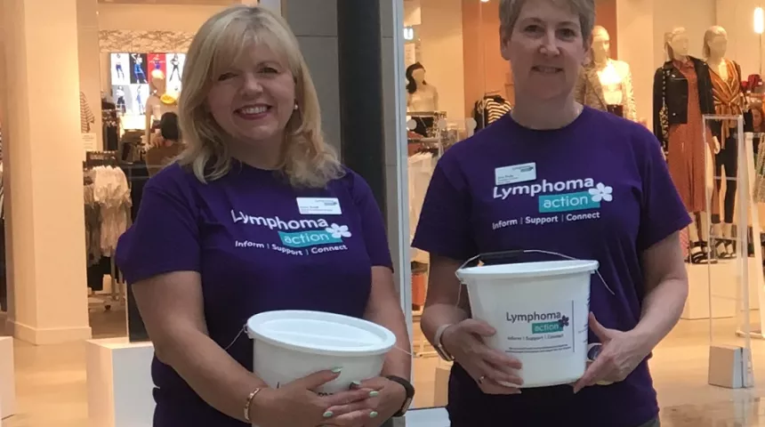 Two females holing Lymphoma Action collection buckets