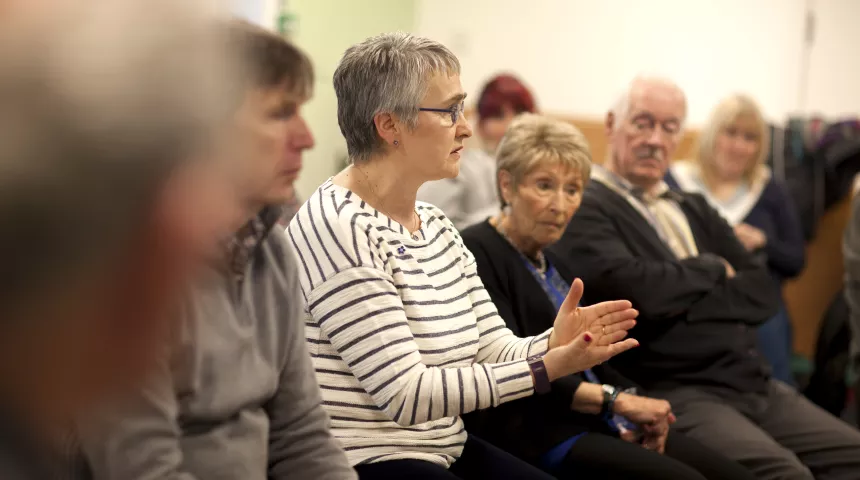 Image of person speaking out of group 