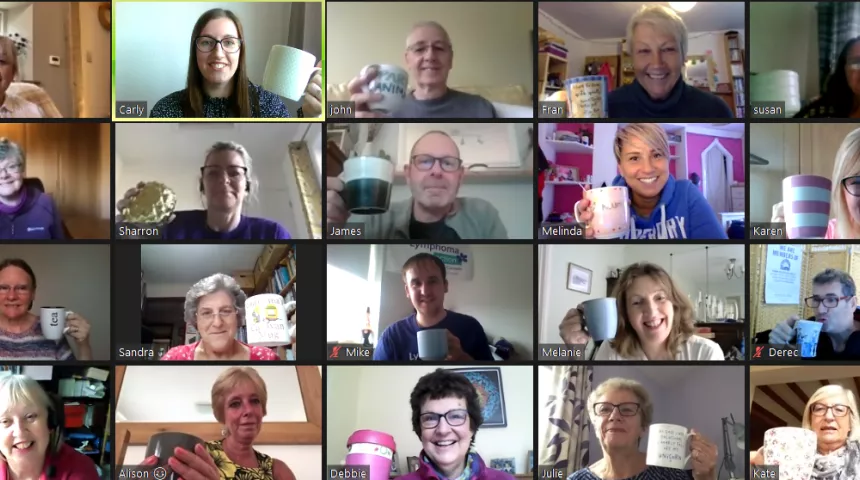 People holding up coffee cups on Zoom call