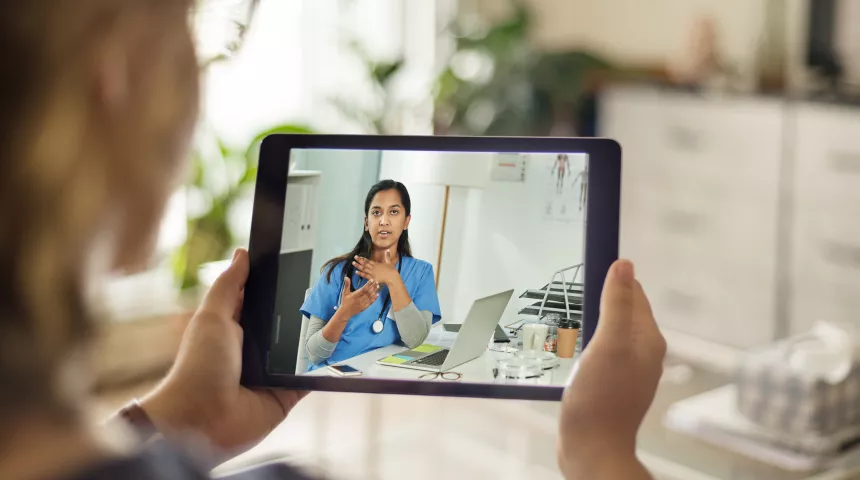 Woman having an appointment with her doctor by iPad