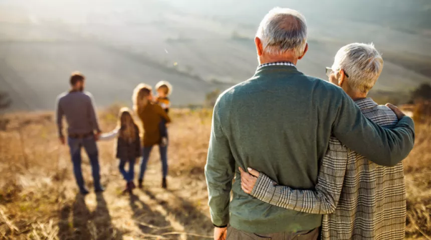 Couple looking over towards younger family