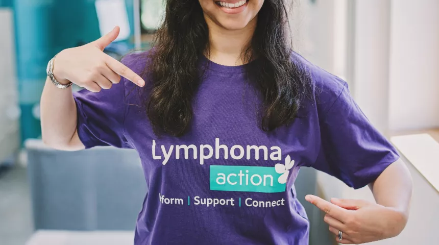Smiling woman wearing a Lymphoma Action T-shirt