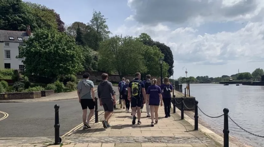 several walkers in Lymphoma Action t-shirts walking along river 