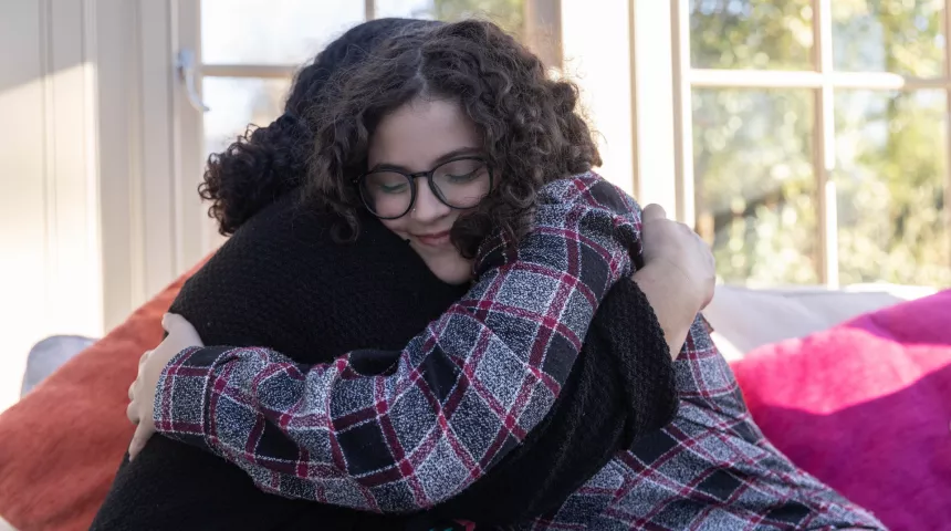 Mother and daughter hugging