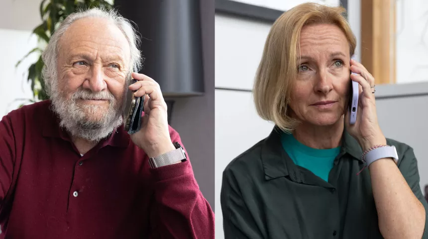 A man with white hair and a beard in a red top, and a woman with blond hair and grey top are both on their mobiles