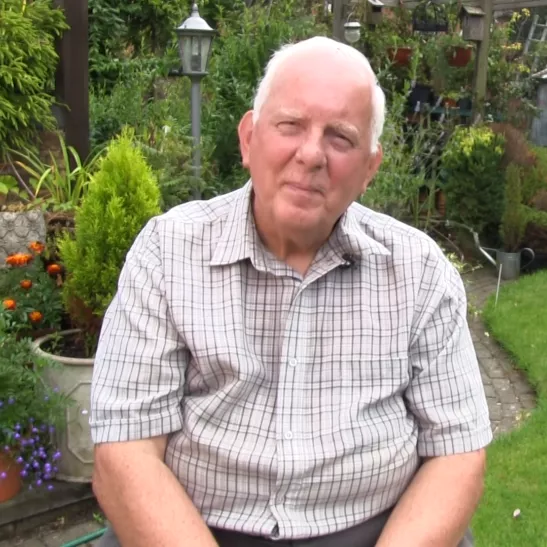 Bernard sitting in his garden 