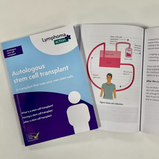 Two Autologous stem cell transplant books - one open on a page with a diagram explaining the process of stem cell collection, and the other book is showing the light blue front cover