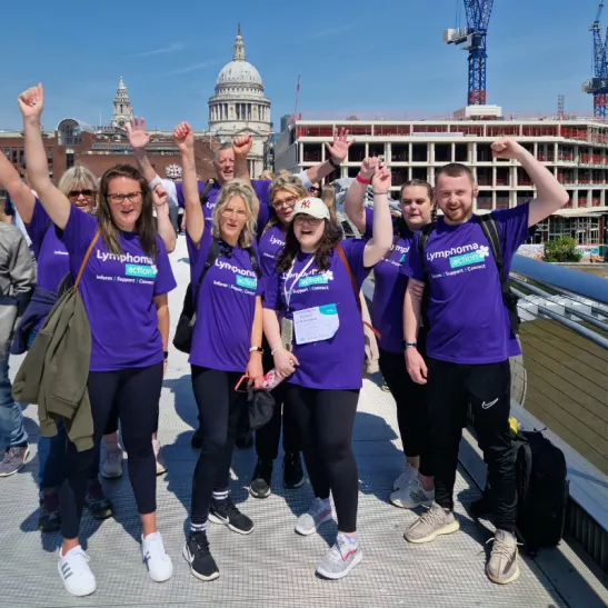 Group of people wearing Lymphoma Action T-shirts with St Paul's Cathedral in background