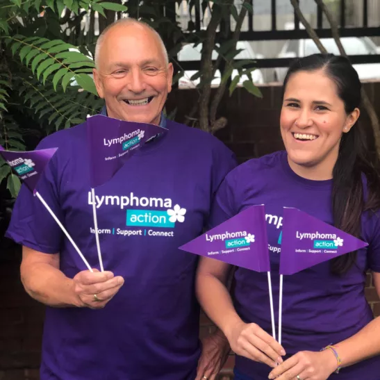 Two Lymphoma Action volunteers waving flags