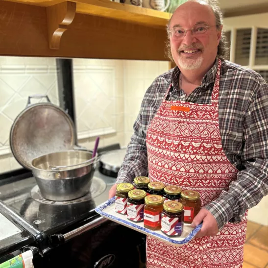 Alister holding homemade jams and preserves