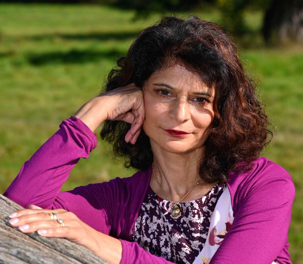 Woman with full head of hair looking ahead