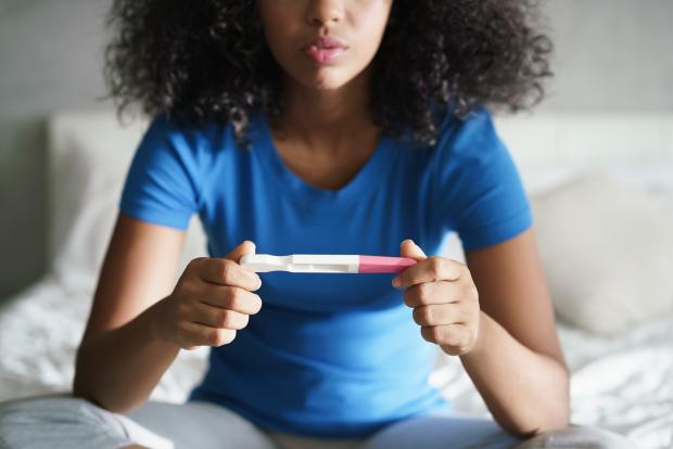 Lady looking at pregnancy test