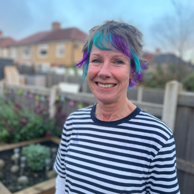 Woman with hair dyed purple and teal - Lymphoma Action brand colours